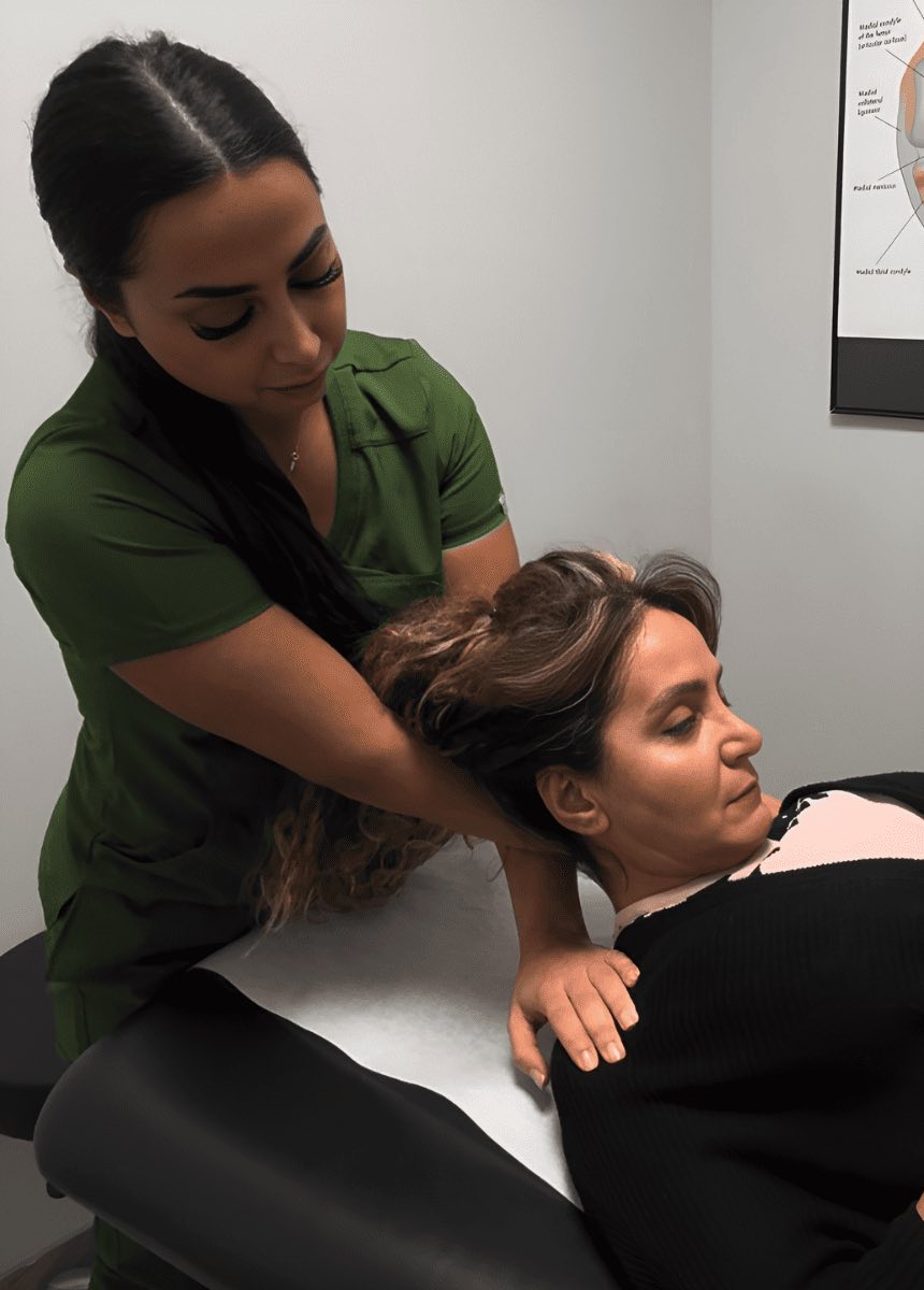 Shahrzad Ebrahimi gives osteopathy treatment to patient's neck